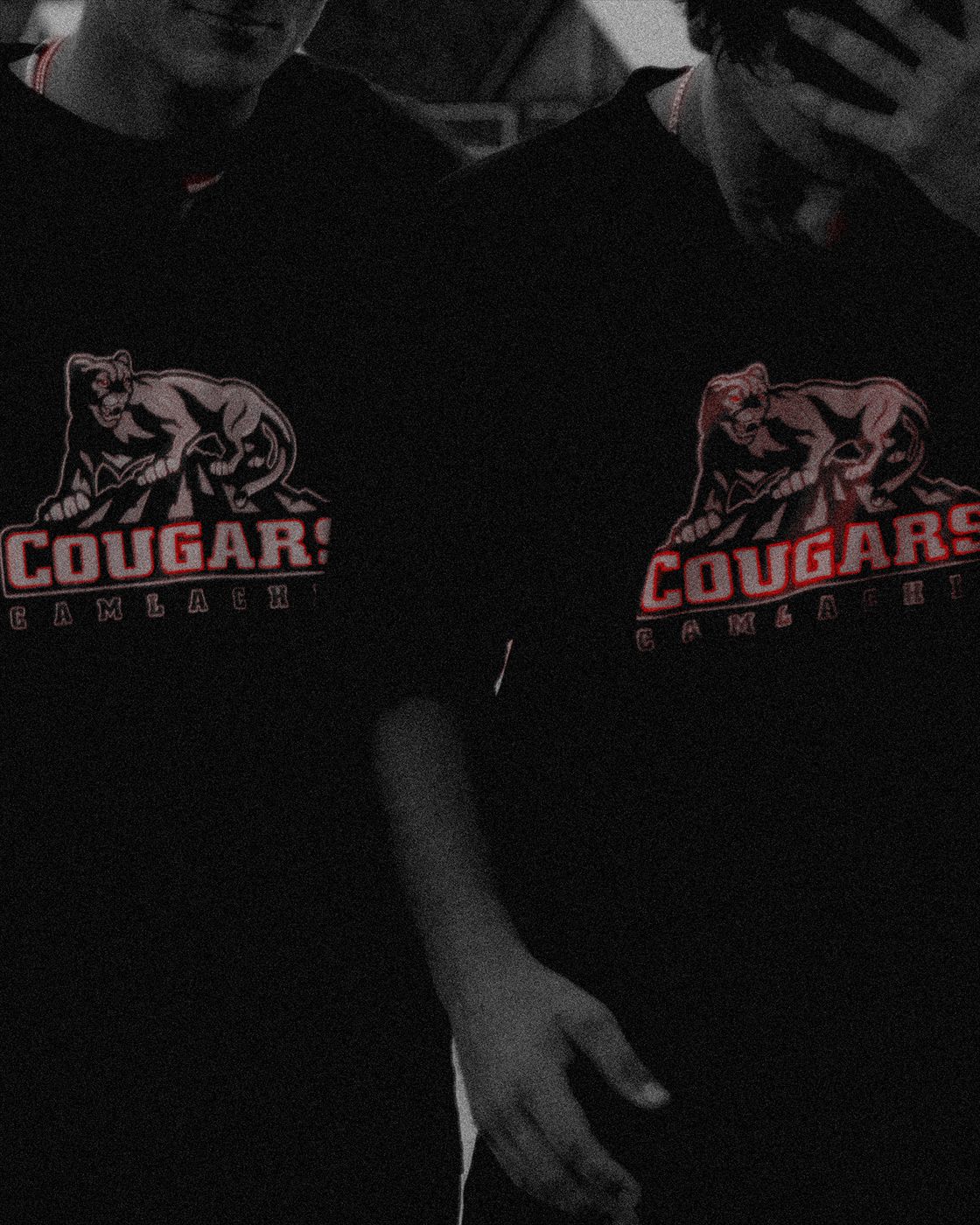 Two athletes wearing Cougars Camlachie shirts.